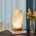 Tischleuchte mit Wellendesign und LED-Licht -    Zorenza