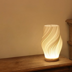 Tischleuchte mit Wellendesign und LED-Licht -    Zorenza