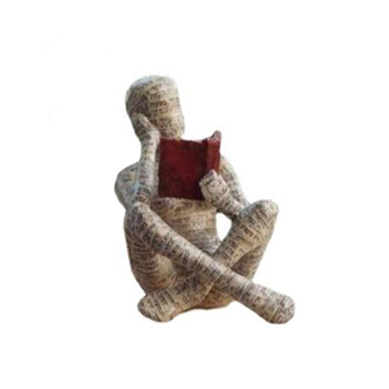Lesende Figur aus Kunstharz mit Zeitungsdruck-Optik Zorenza